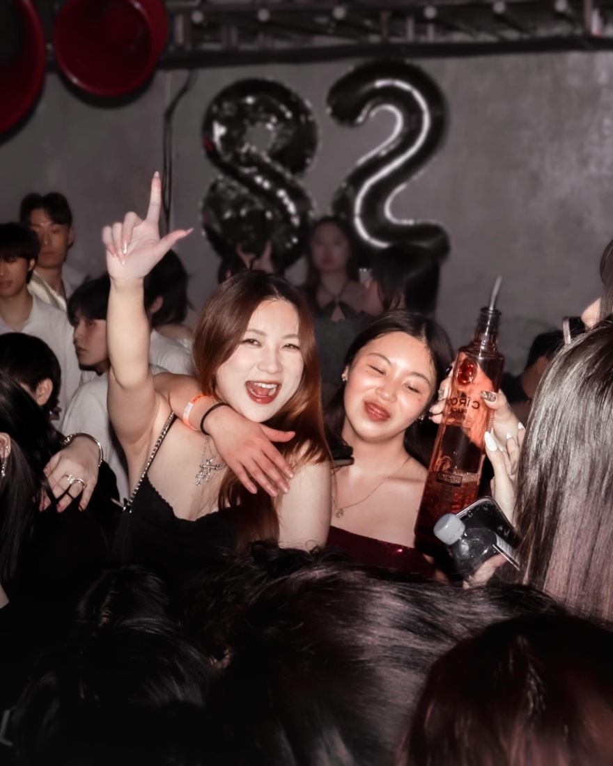 Guests celebrating under 82 balloons at an *82 party volume